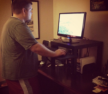 guy standing at desk