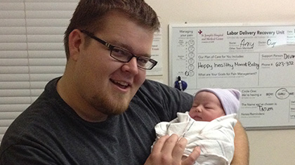 dad holding newborn baby