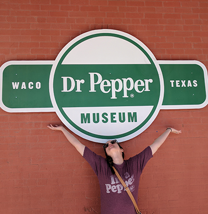 woman in front of dr pepper museum in waco, tx